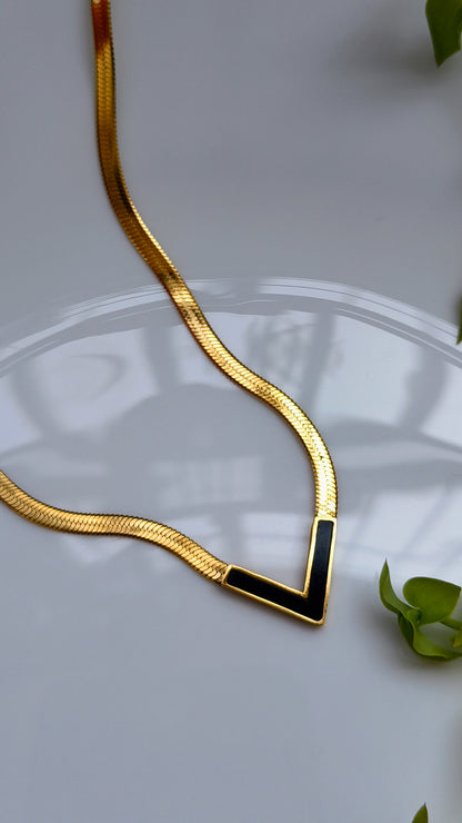 Elegant gold V shaped bold necklace with black crystals